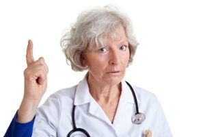 Nurse with scolding look holding finger up