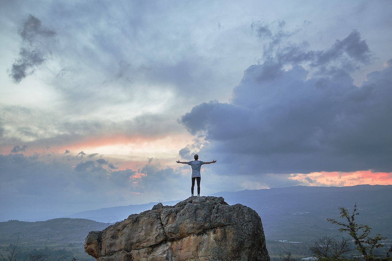 person standing on top of mountain